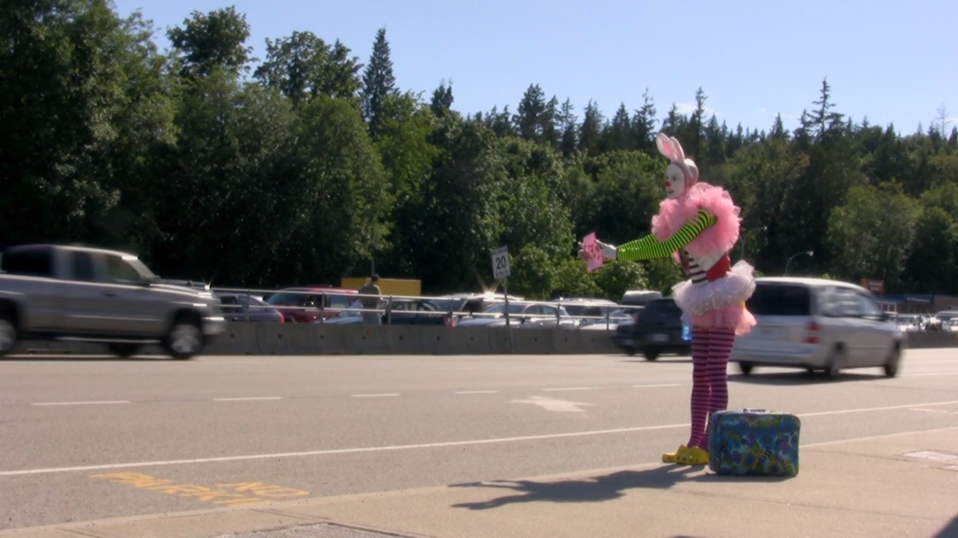 Smith dressed as a clown standing roadside