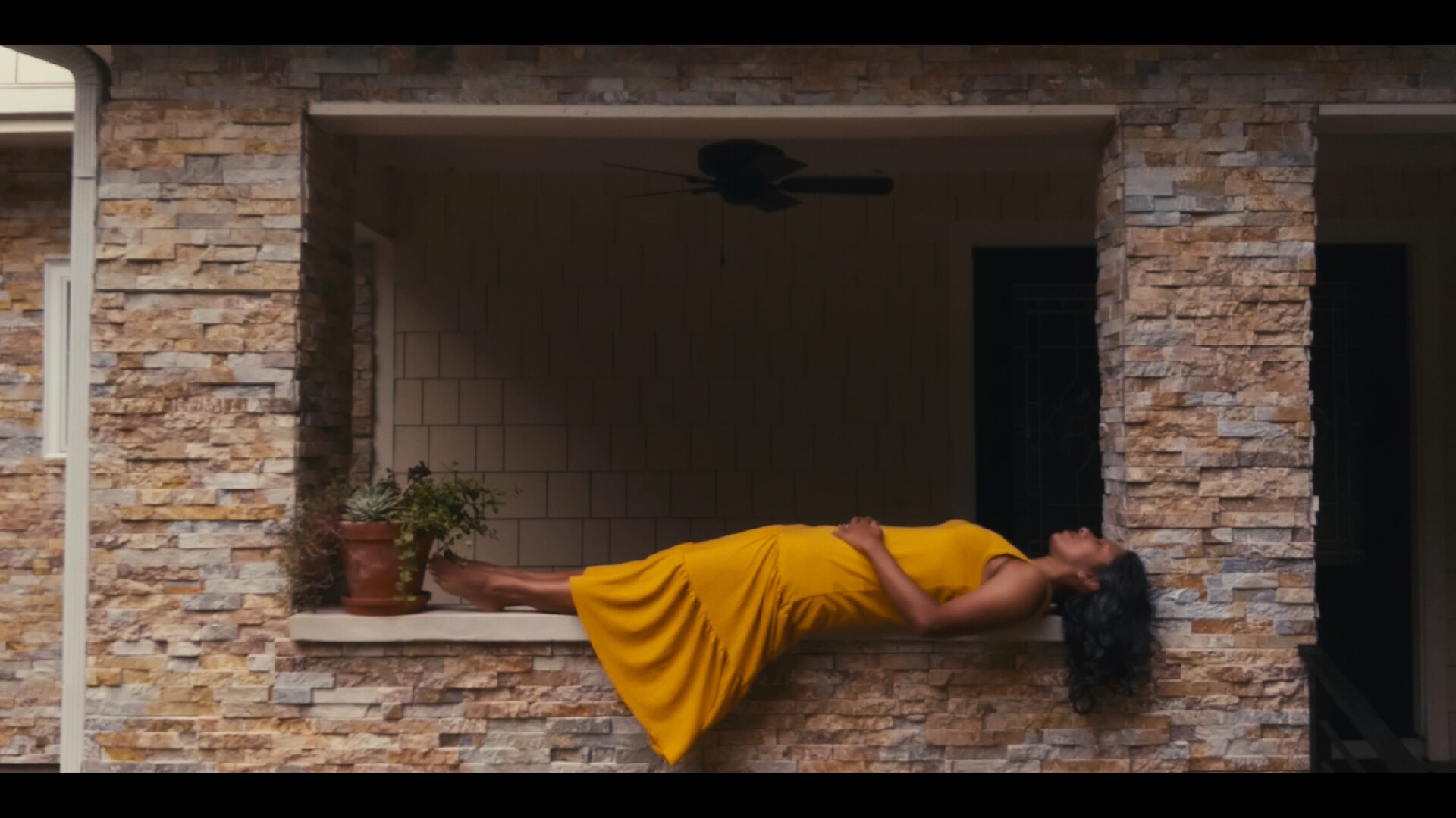 Image of a beautiful Brown Indian woman on a front porch in the humid US South